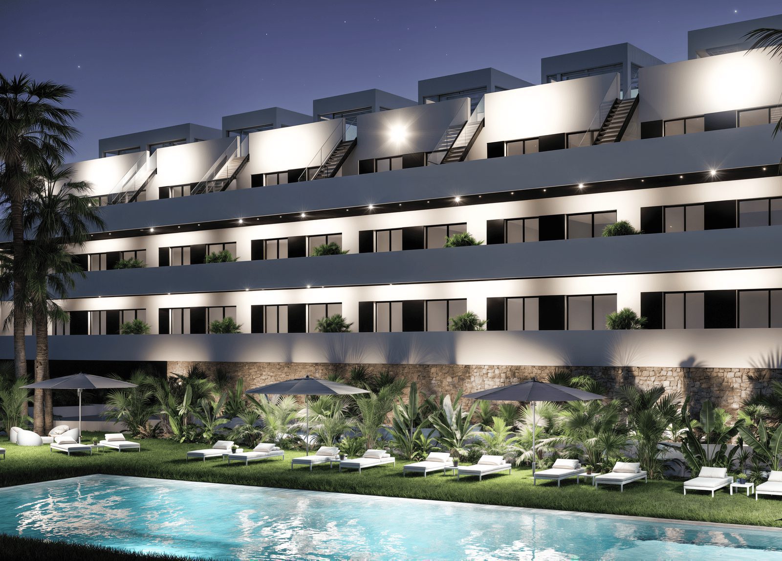 Night view of a luxurious pool area and modern architecture of a 2-bedroom penthouse in Finestrat - The Estates