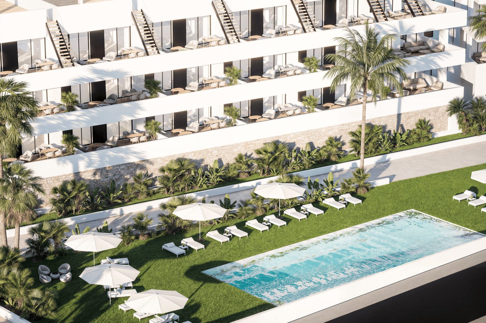 A view of the pool and landscaped gardens surrounding a 2-bedroom penthouse in Finestrat - The Estates
