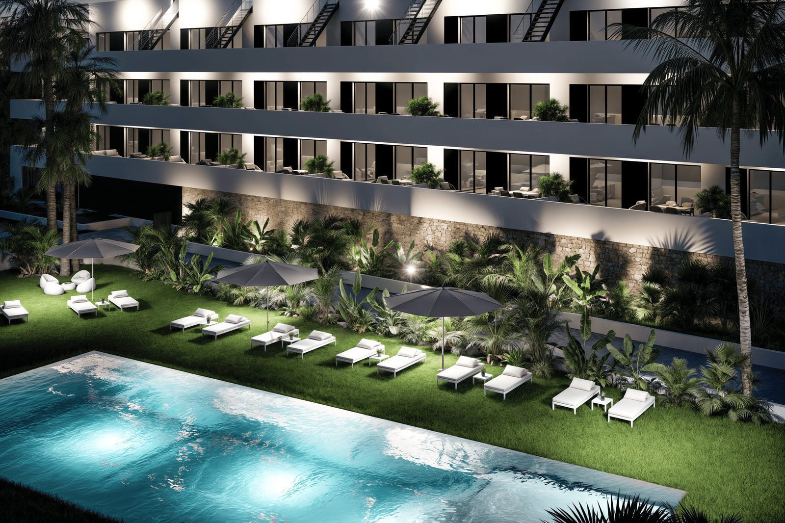Exterior view of a luxurious pool area and landscaping surrounding a 2-bedroom penthouse in Finestrat - The Estates