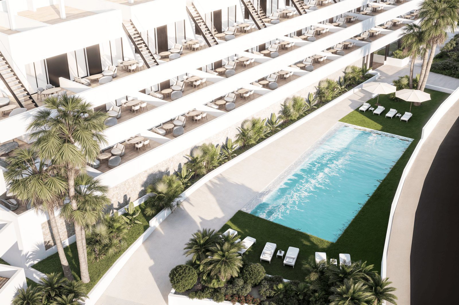 An aerial view of the pool and gardens surrounding a 2-bedroom penthouse in Finestrat - The Estates