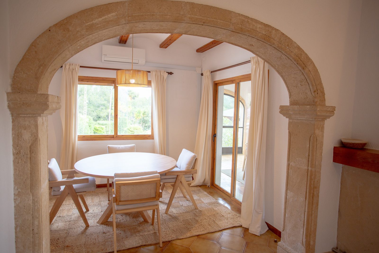A bright dining area with arched stone details in a 2-bedroom villa in Javea / Xabia - The Estates