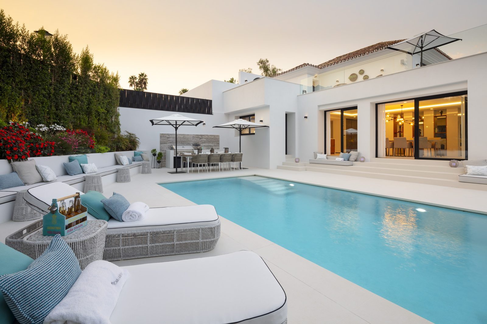 Luxury villa courtyard with swimming pool, sun loungers and outdoor dining in Nueva Andalucía, Málaga - The Estates