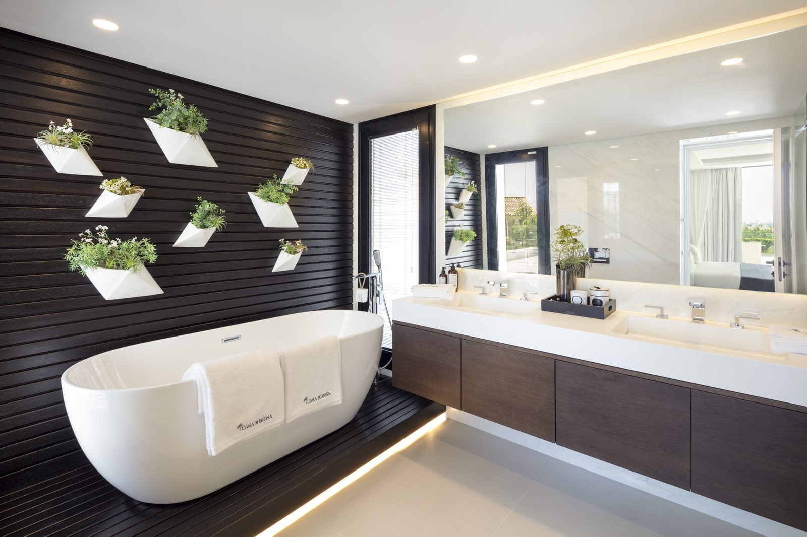 Contemporary bathroom with freestanding bathtub, double vanity and botanical wall planters in a 5-bedroom villa in Málaga - The Estates