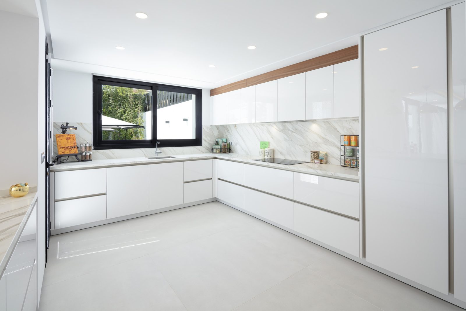 Modern white kitchen with marble worktops in a 5-bedroom villa in Málaga - The Estates