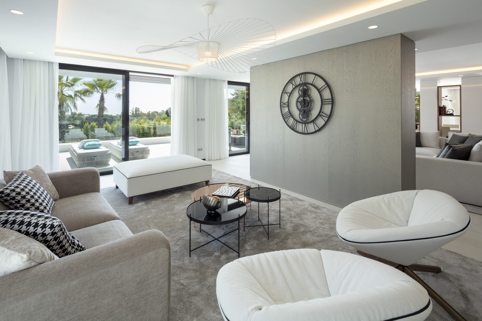 Contemporary living room with designer seating and garden views of a