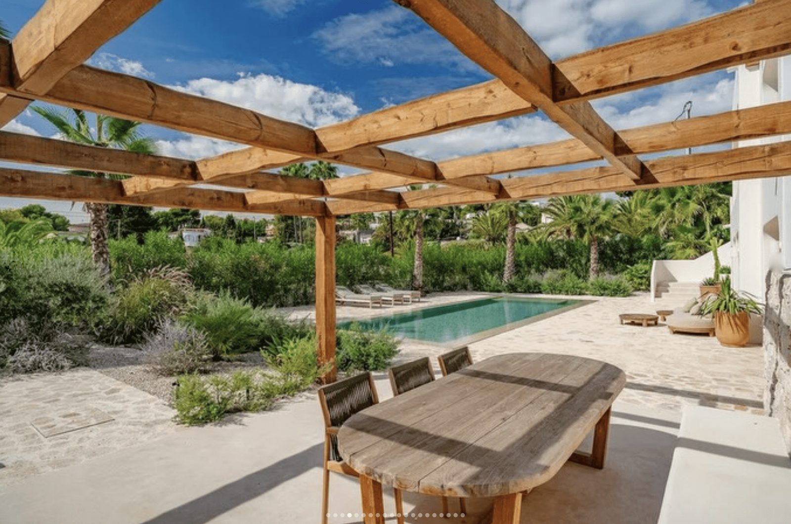 Outdoor dining area and pool in a lush garden of a 5-bedroom villa in Benissa - The Estates