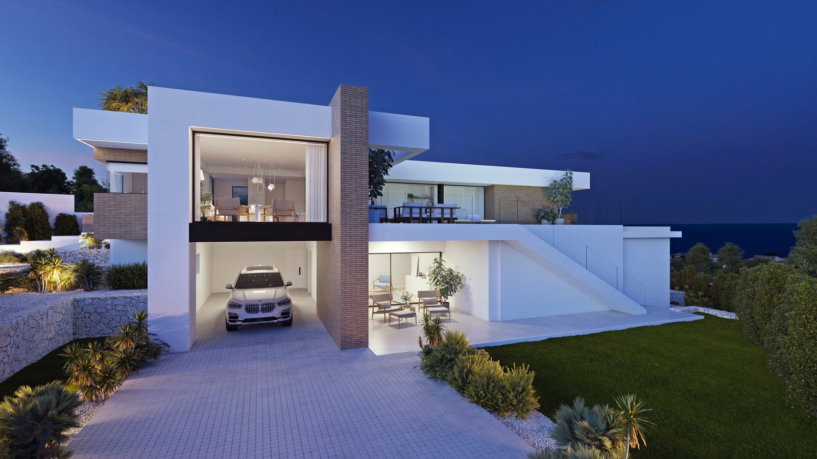 Modern white villa exterior with garage, terraces and landscaped gardens overlooking the sea at dusk, of a 3-bedroom villa in Benitachell - The Estates