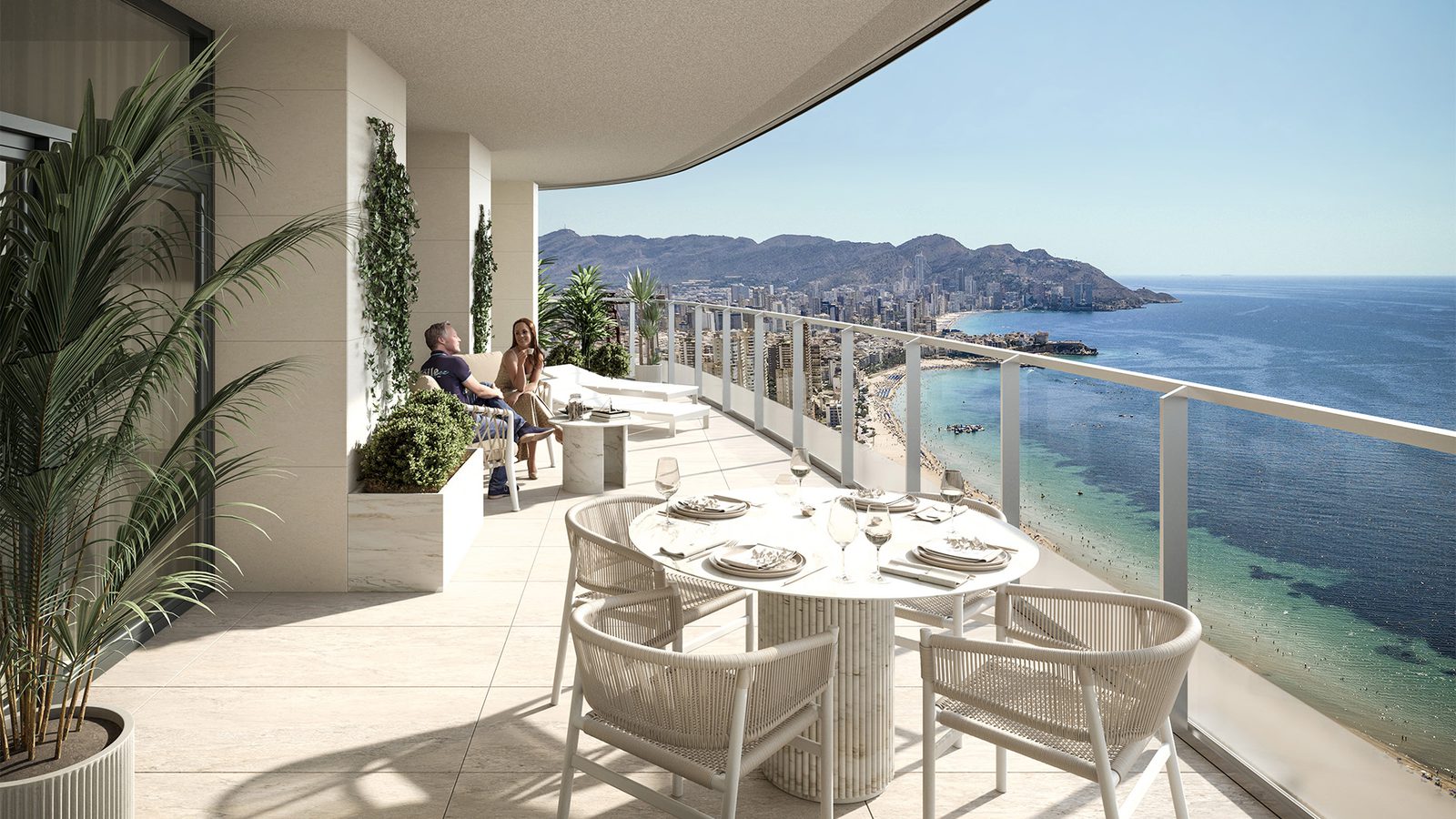 A spacious balcony with dining area and stunning sea views of a 4-bedroom apartment in Benidorm - The Estates