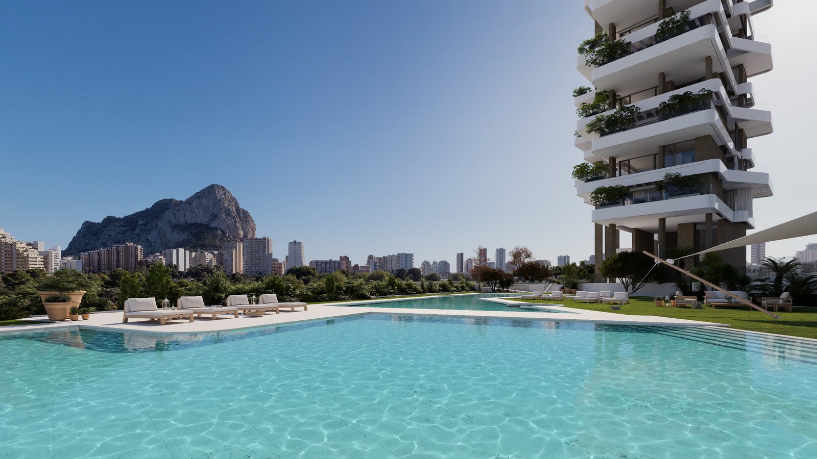 A pool and landscaped gardens with a modern apartment building and mountain views - The Estates