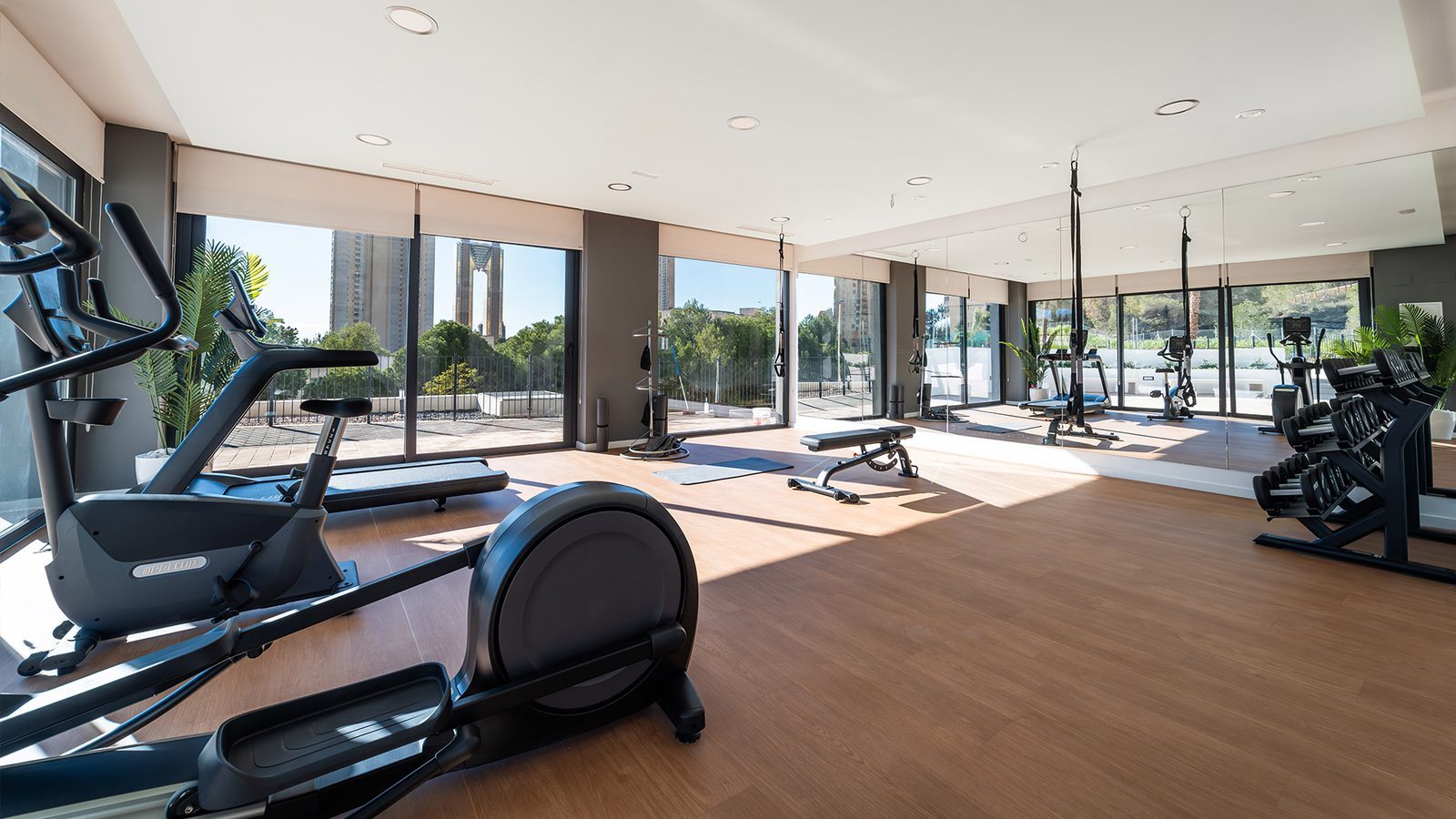 Modern residents' gym with cardio and strength equipment in a 2-bedroom apartment complex in Benidorm - The Estates