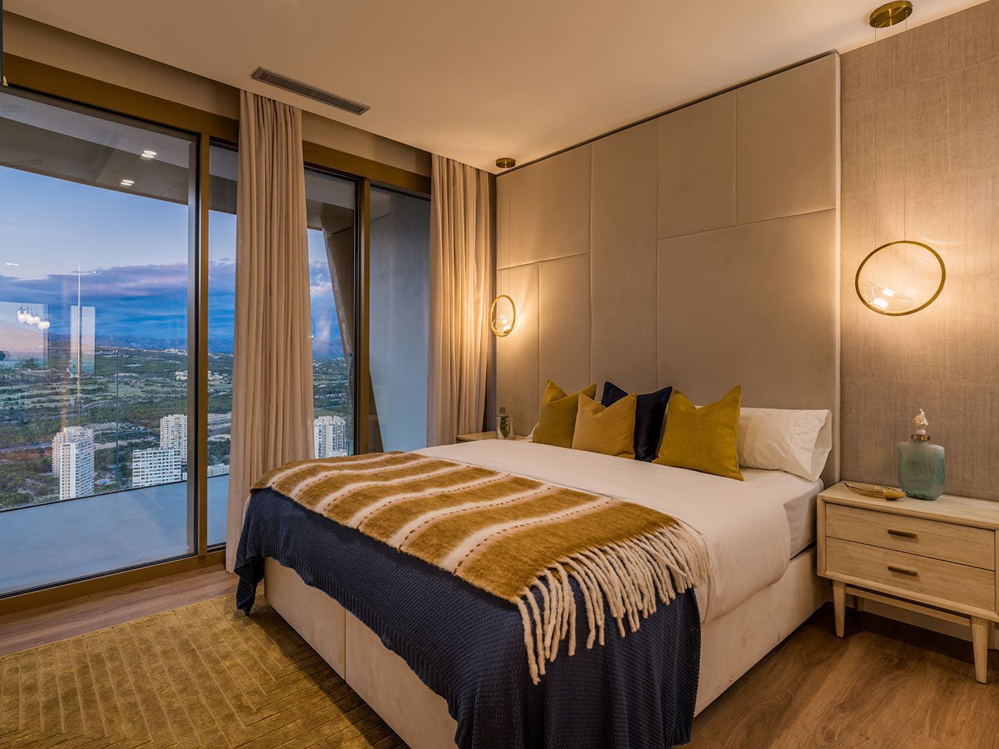 A beautifully styled bedroom with panoramic sea and city views in a 3-bedroom apartment in Benidorm - The Estates