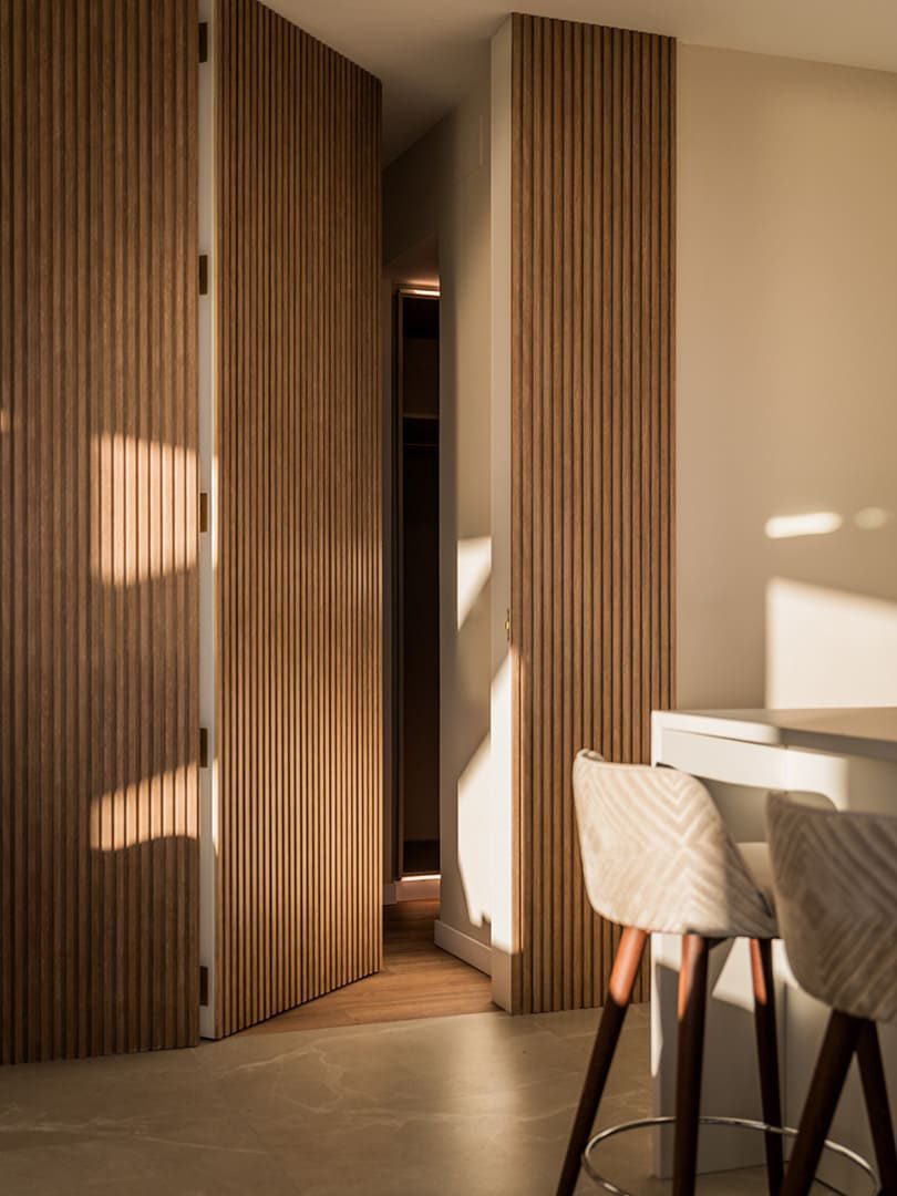 Stylish wooden paneling and a modern dining area in a 3-bedroom apartment in Benidorm - The Estates