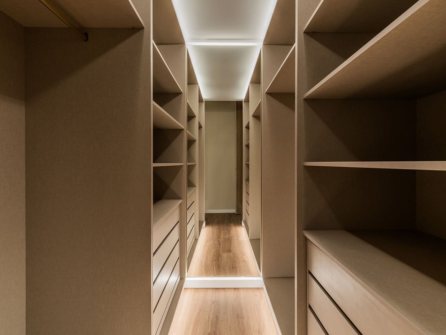 A spacious walk-in wardrobe with built-in shelving and drawers in a 3-bedroom apartment in Benidorm - The Estates