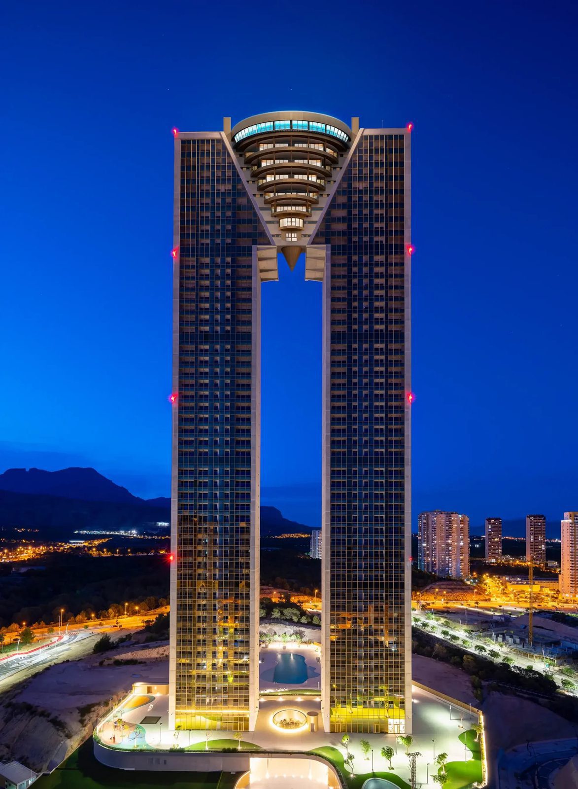 Night view of a modern apartment building with sea and city views - The Estates