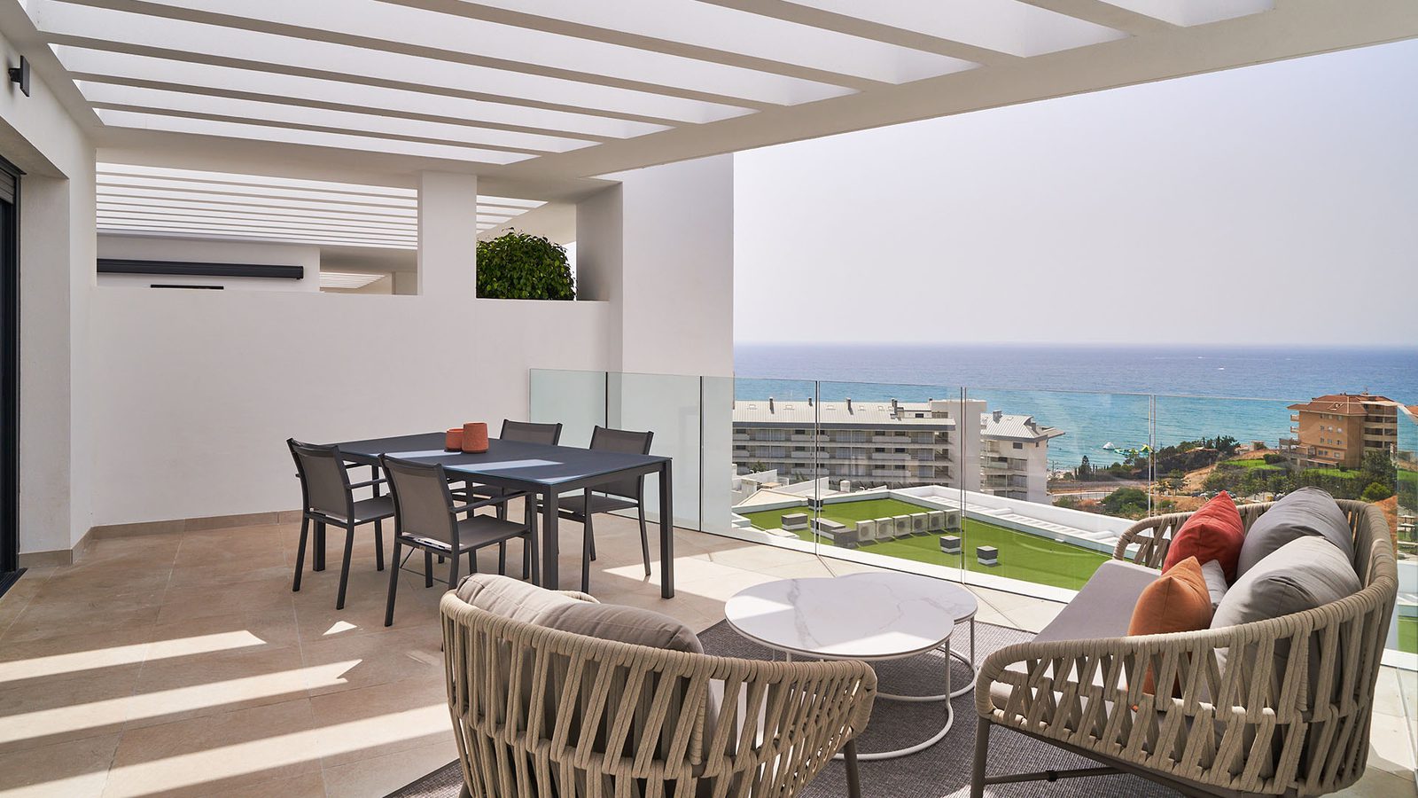 A bright, modern terrace with sea views of a 3-bedroom apartment in Fuengirola - The Estates