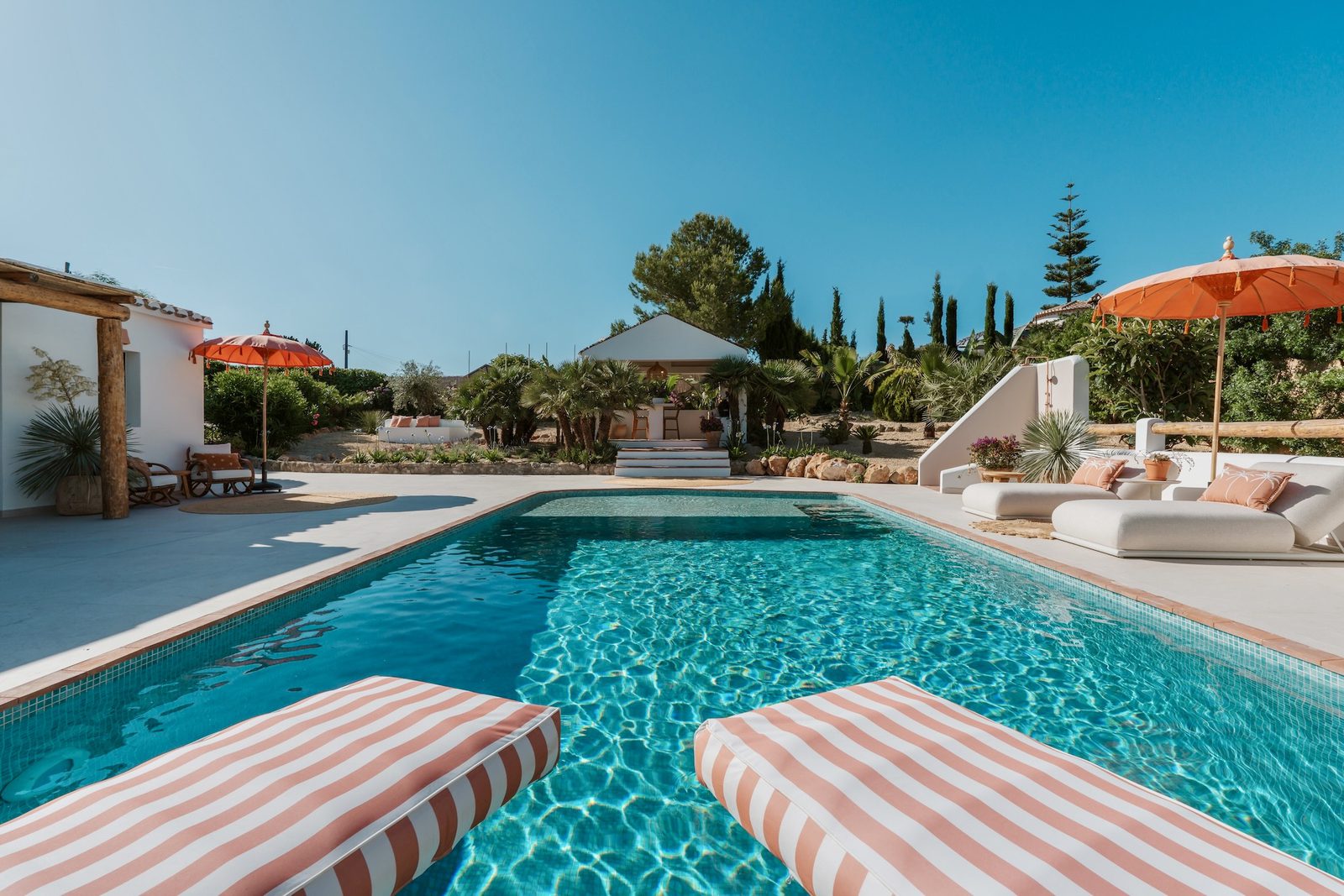 A beautiful pool area with sun loungers at a 4-bedroom villa in Javea - The Estates