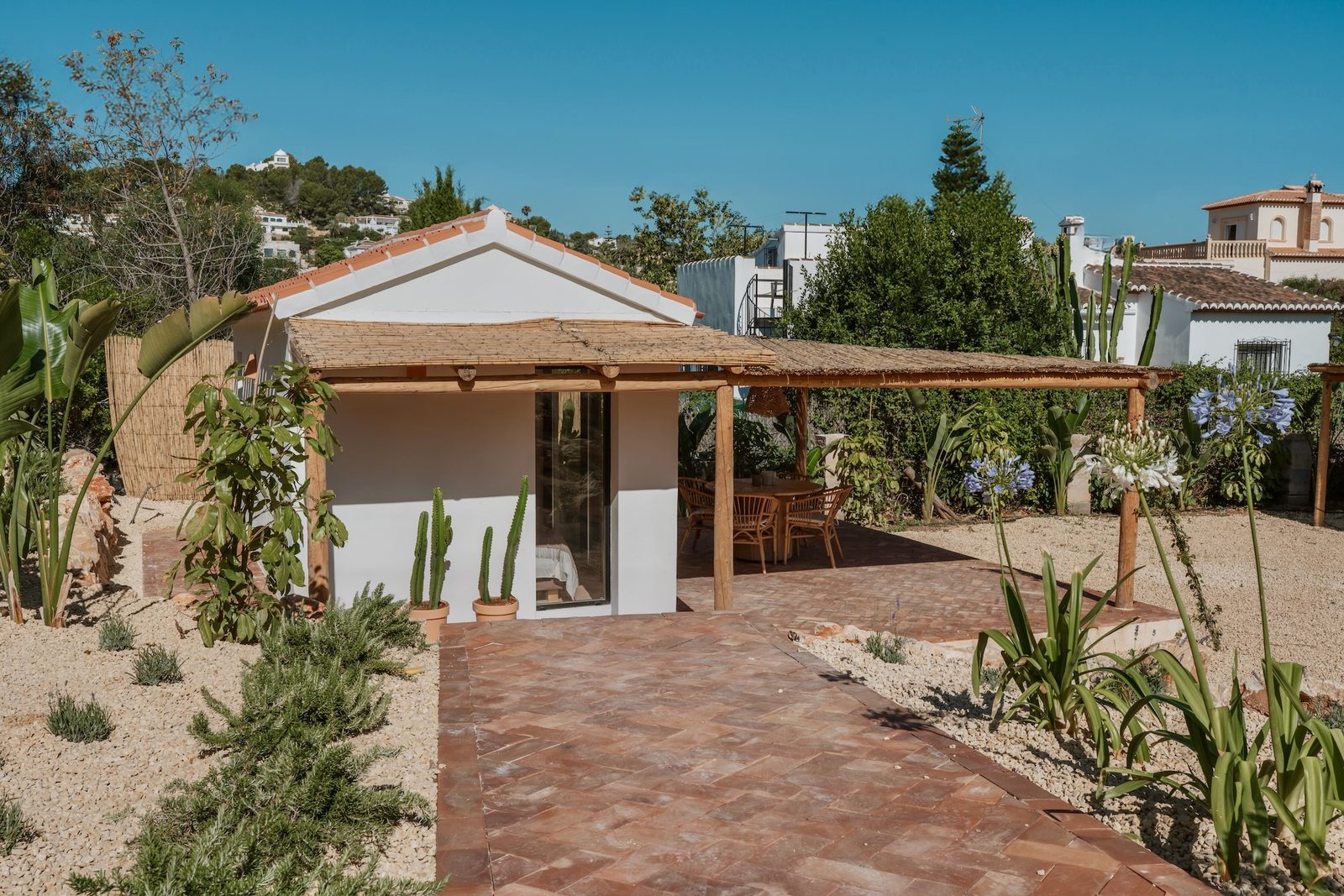 A charming outdoor dining area and garden of a 4-bedroom villa in Javea - The Estates