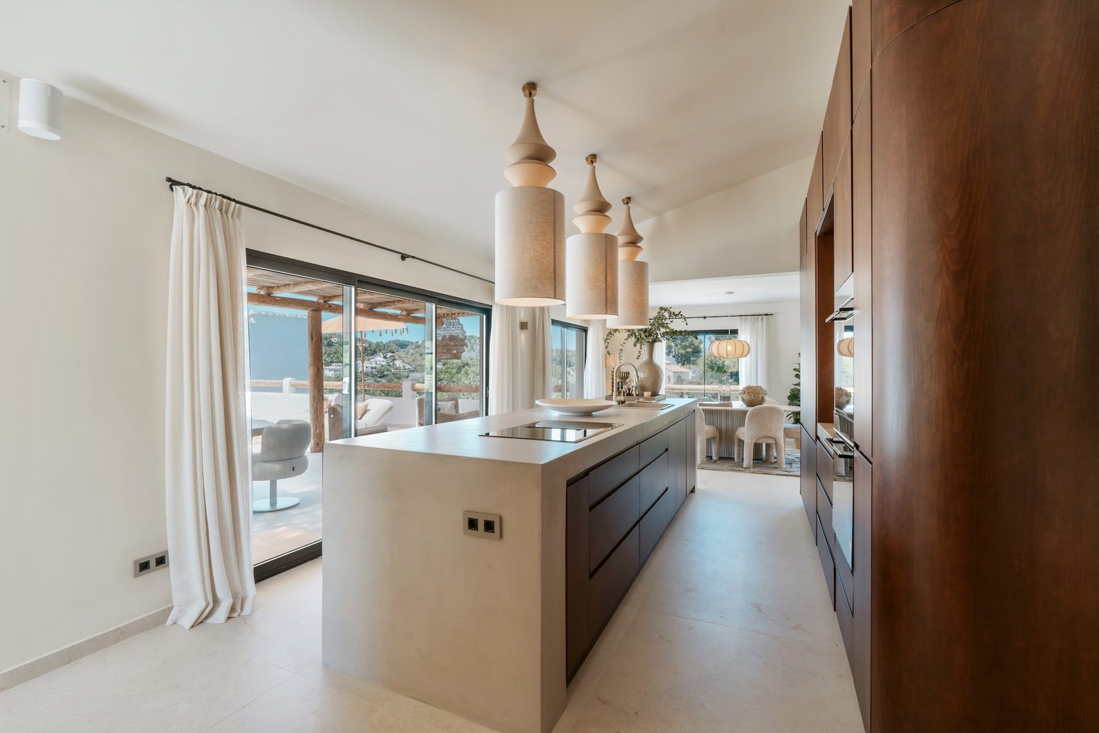 Stylish kitchen with island and views of the garden and mountains in a 4-bedroom villa in Javea - The Estates