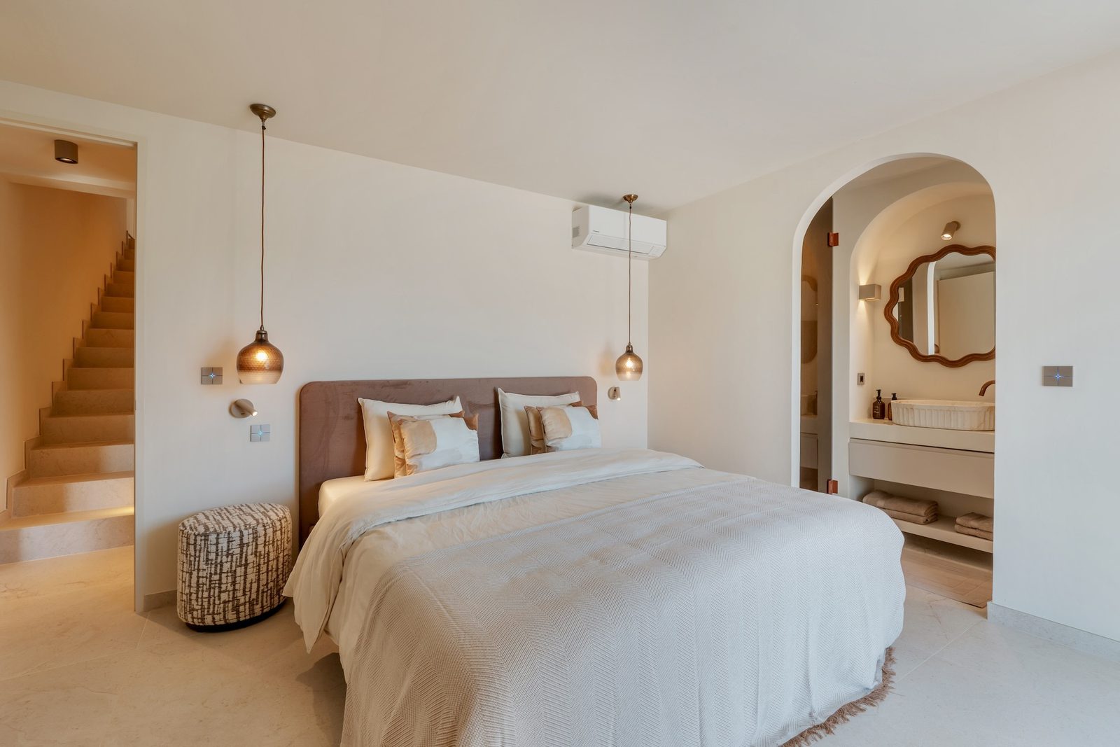 A stylish bedroom with staircase and ensuite bathroom in a 4-bedroom villa in Javea - The Estates