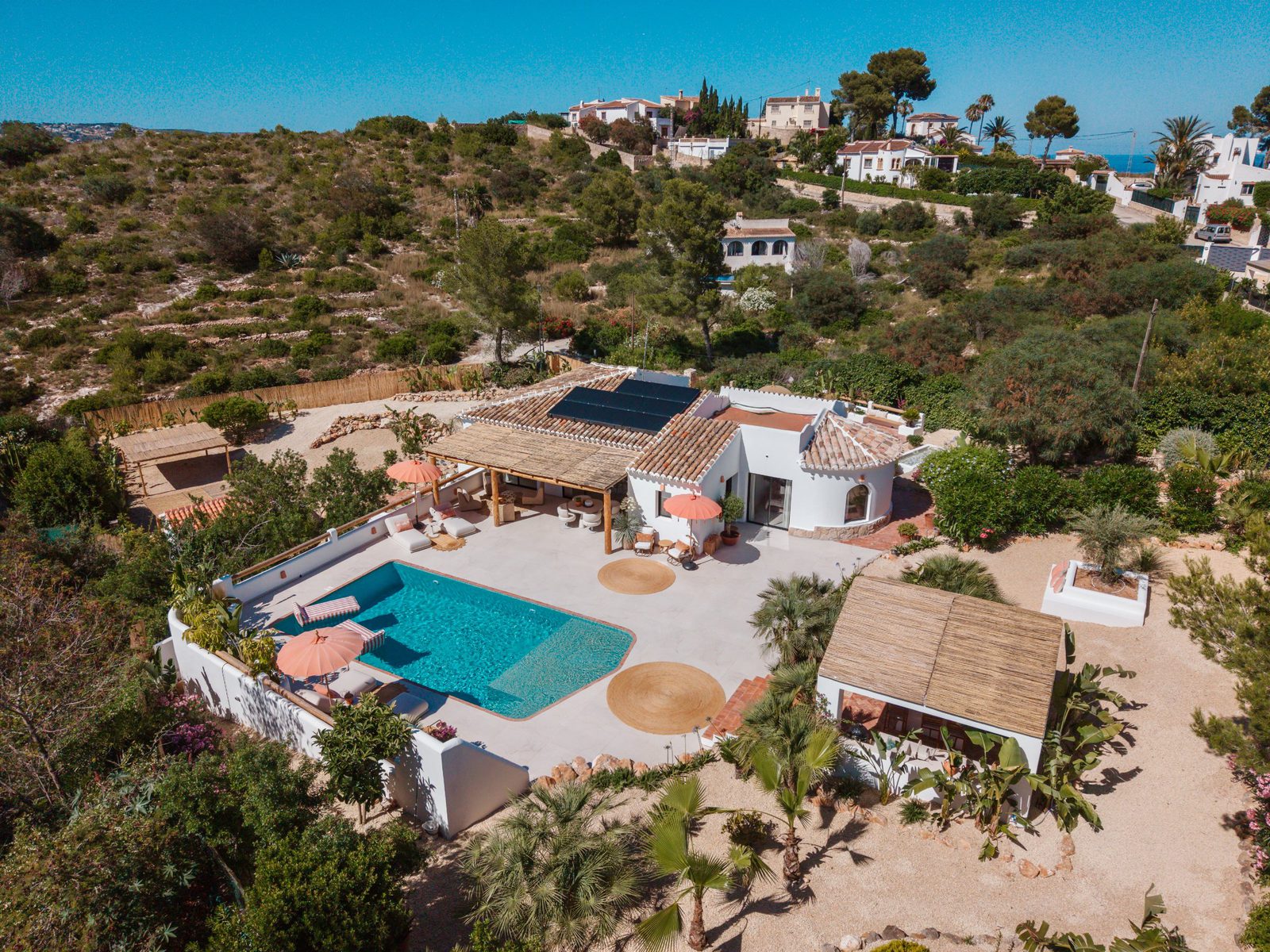 Aerial view of a beautiful villa with a pool and garden in Javea - The Estates