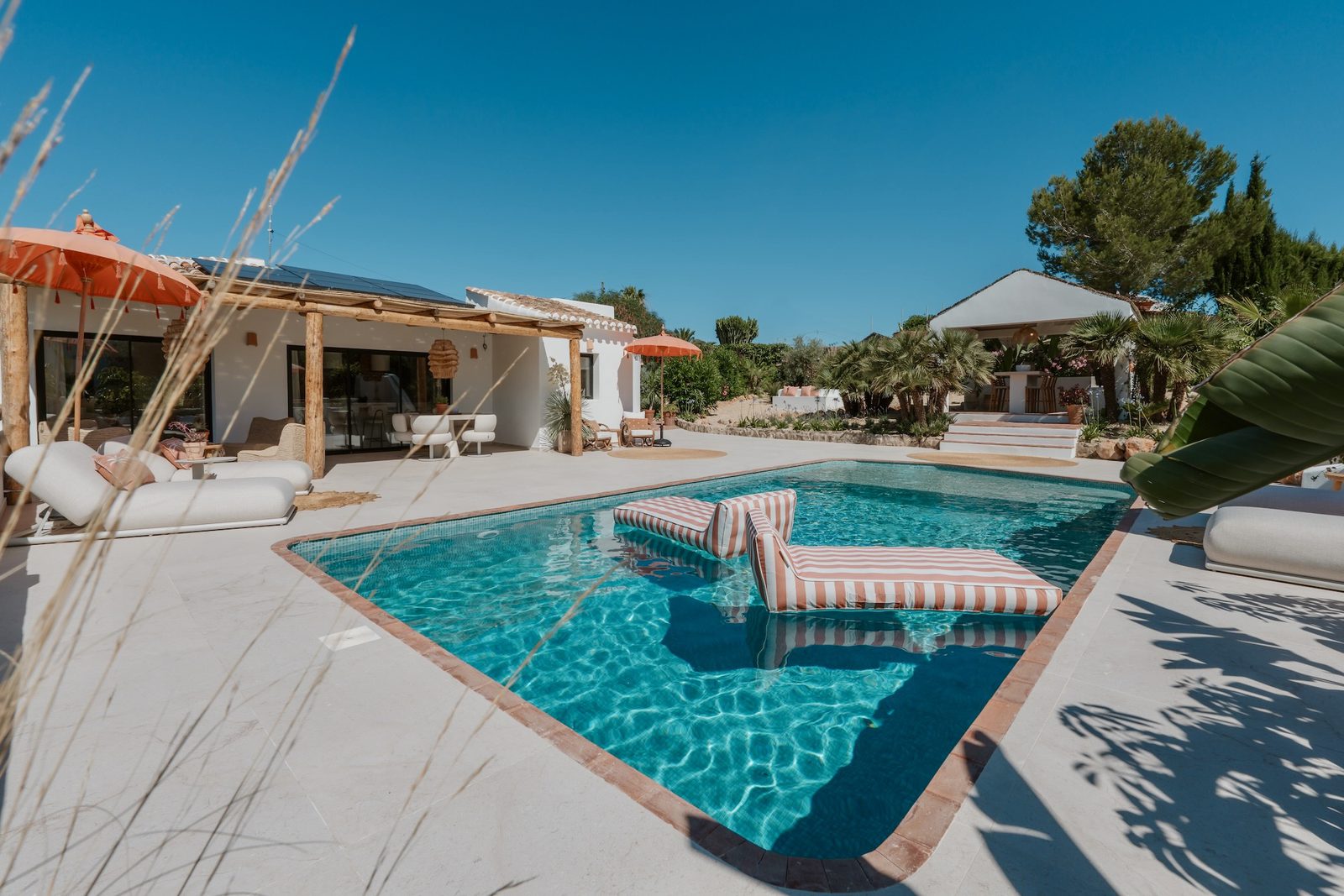 A stunning pool area with sun loungers at a 4-bedroom villa in Javea - The Estates