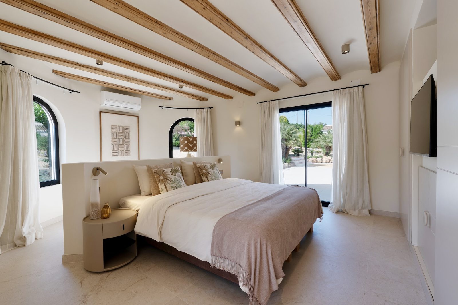 Stylish bedroom interior with exposed beams and garden views in a 4-bedroom villa in Javea - The Estates