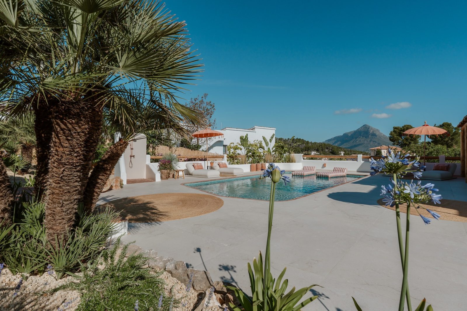 A sunny terrace and pool area of a 4-bedroom villa in Javea - The Estates