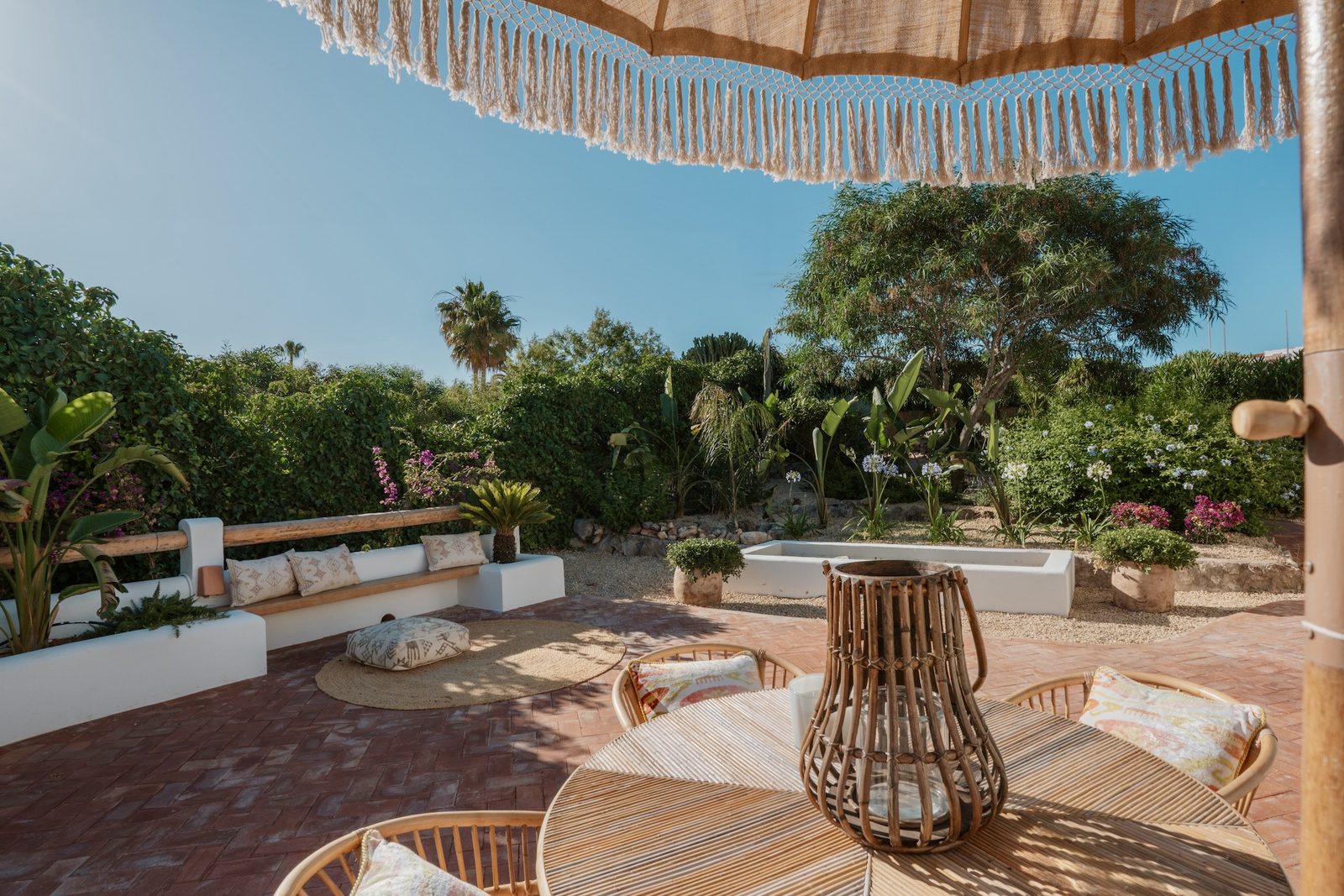 A relaxing garden area with seating and a patio in a 4-bedroom villa in Javea - The Estates