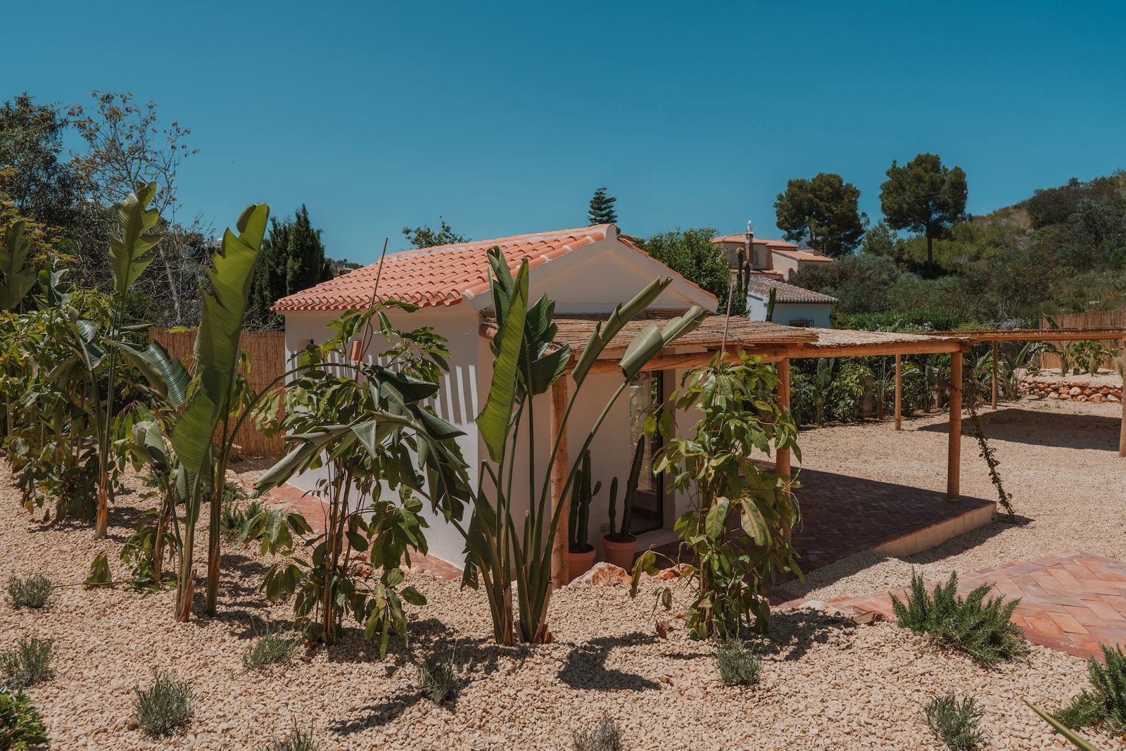 A charming garden area with a pergola and lush greenery at a 4-bedroom villa in Javea - The Estates