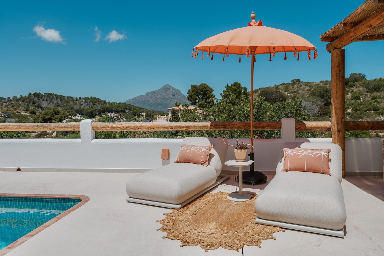 Relaxing poolside lounge area with mountain views at a 4-bedroom villa in Javea - The Estates
