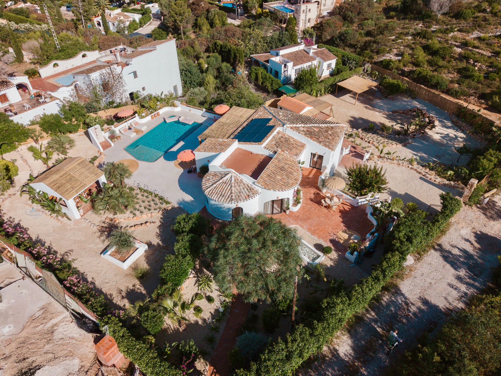 An aerial view of a beautiful villa with a pool and garden in Javea - The Estates