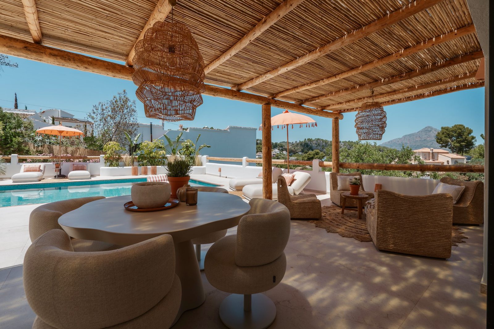 Stylish outdoor dining area with mountain views at a 4-bedroom villa in Javea - The Estates