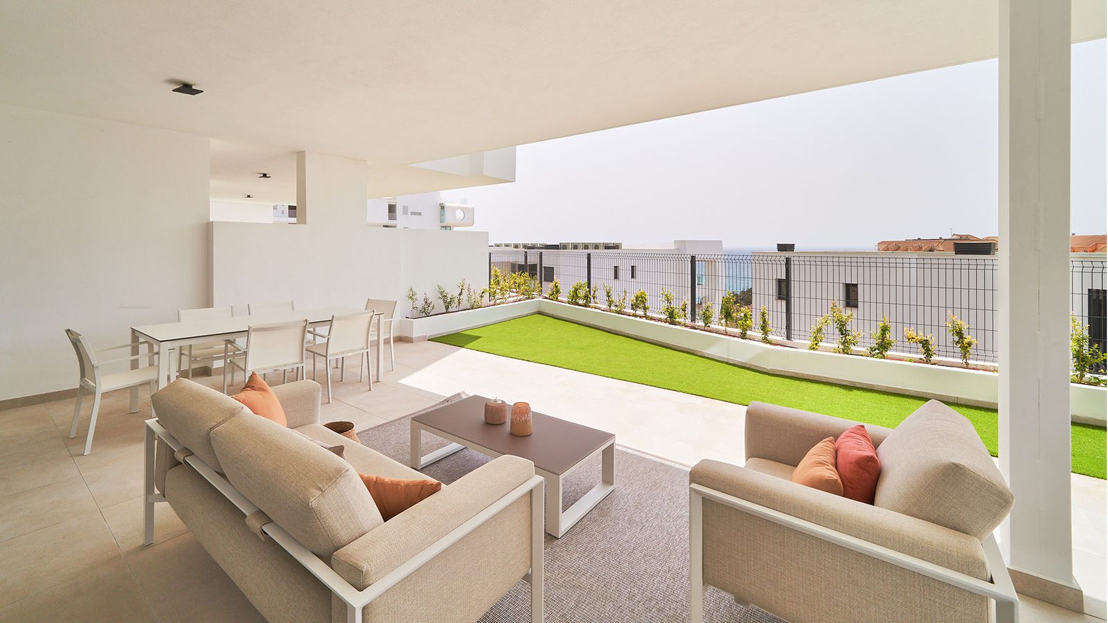 A bright, modern terrace with seating and a garden area in a 3-bedroom apartment in Fuengirola - The Estates