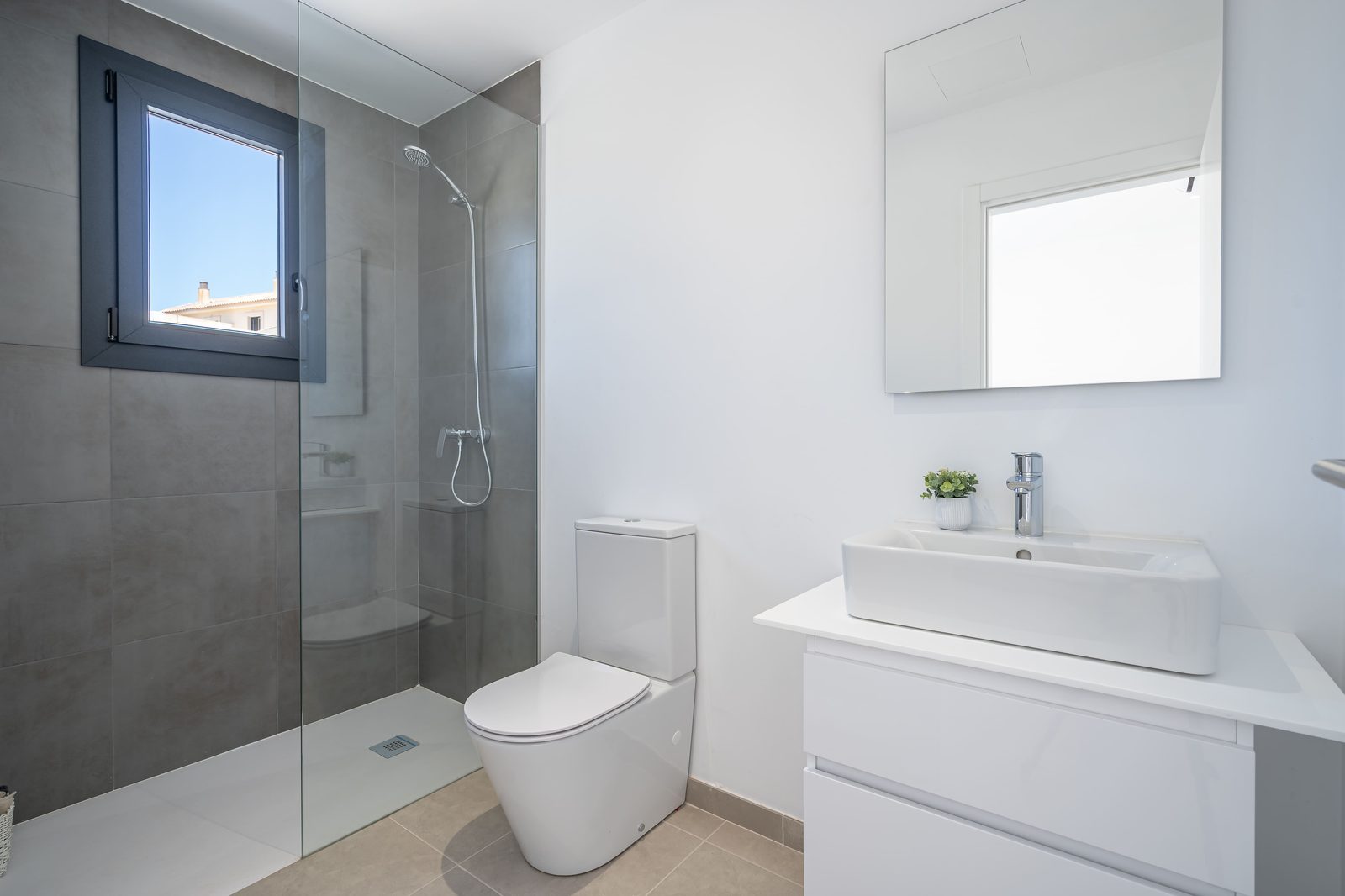A modern bathroom with a walk-in shower and sleek fixtures in a townhouse in Manacor - The Estates