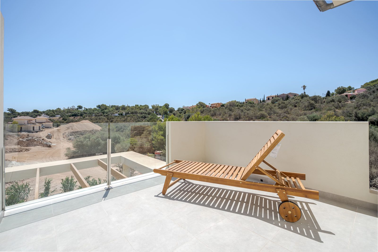 A sun lounger on a terrace overlooking a hillside in Cala Magrana, Manacor - The Estates