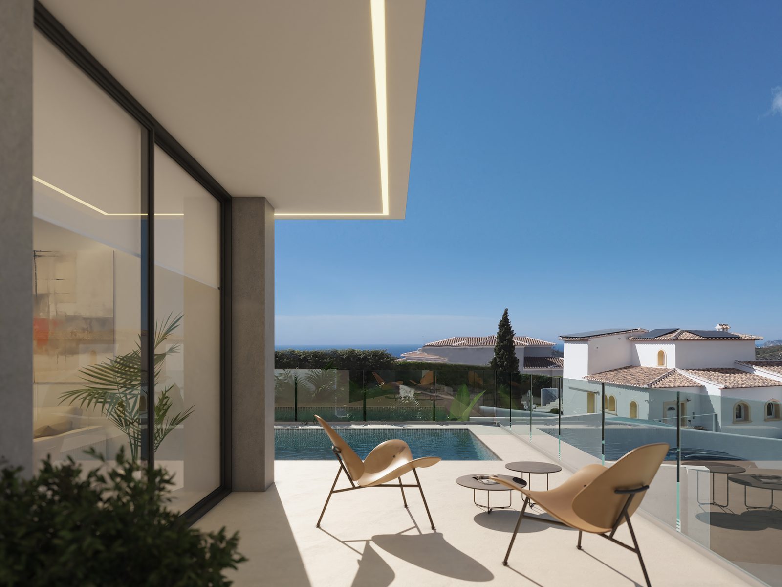 Pool terrace with loungers and sea views at a 3-bedroom villa in Benitachell - The Estates