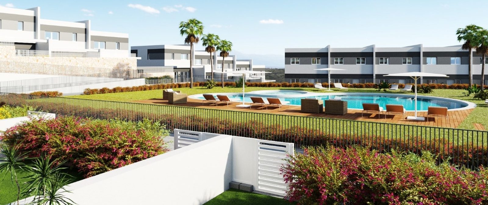 Communal swimming pool with sun loungers and landscaped gardens between modern townhouses in Finestrat - The Estates