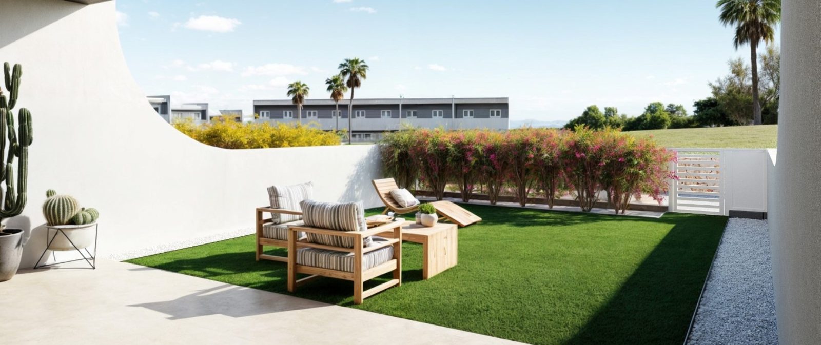 Landscaped garden terrace with outdoor seating and flowering shrubs at a 3-bedroom townhouse in Finestrat - The Estates