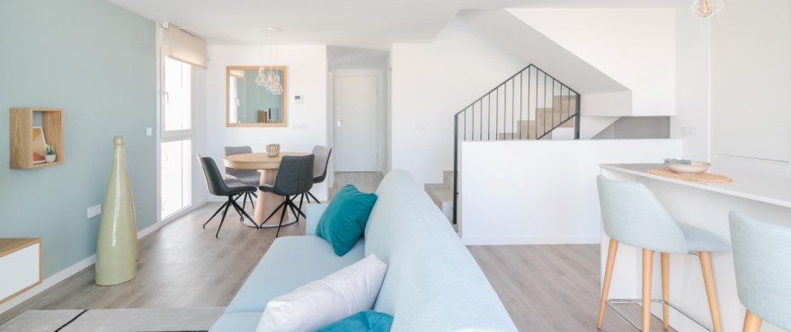 Open-plan living room, dining area and kitchen with staircase in a 3-bedroom townhouse in Finestrat - The Estates