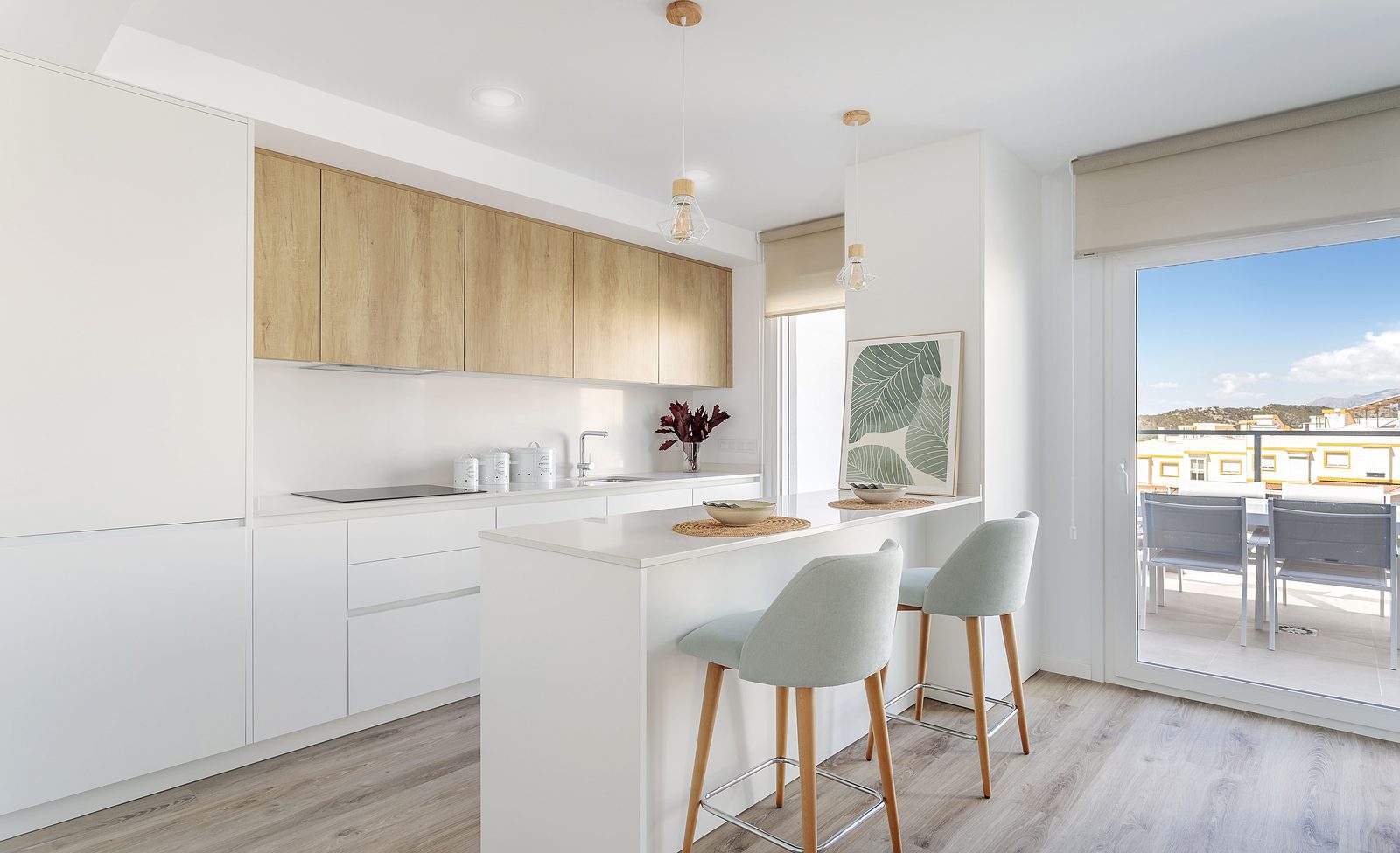 Modern kitchen with breakfast bar and outdoor terrace in a 4-bedroom villa in Finestrat - The Estates