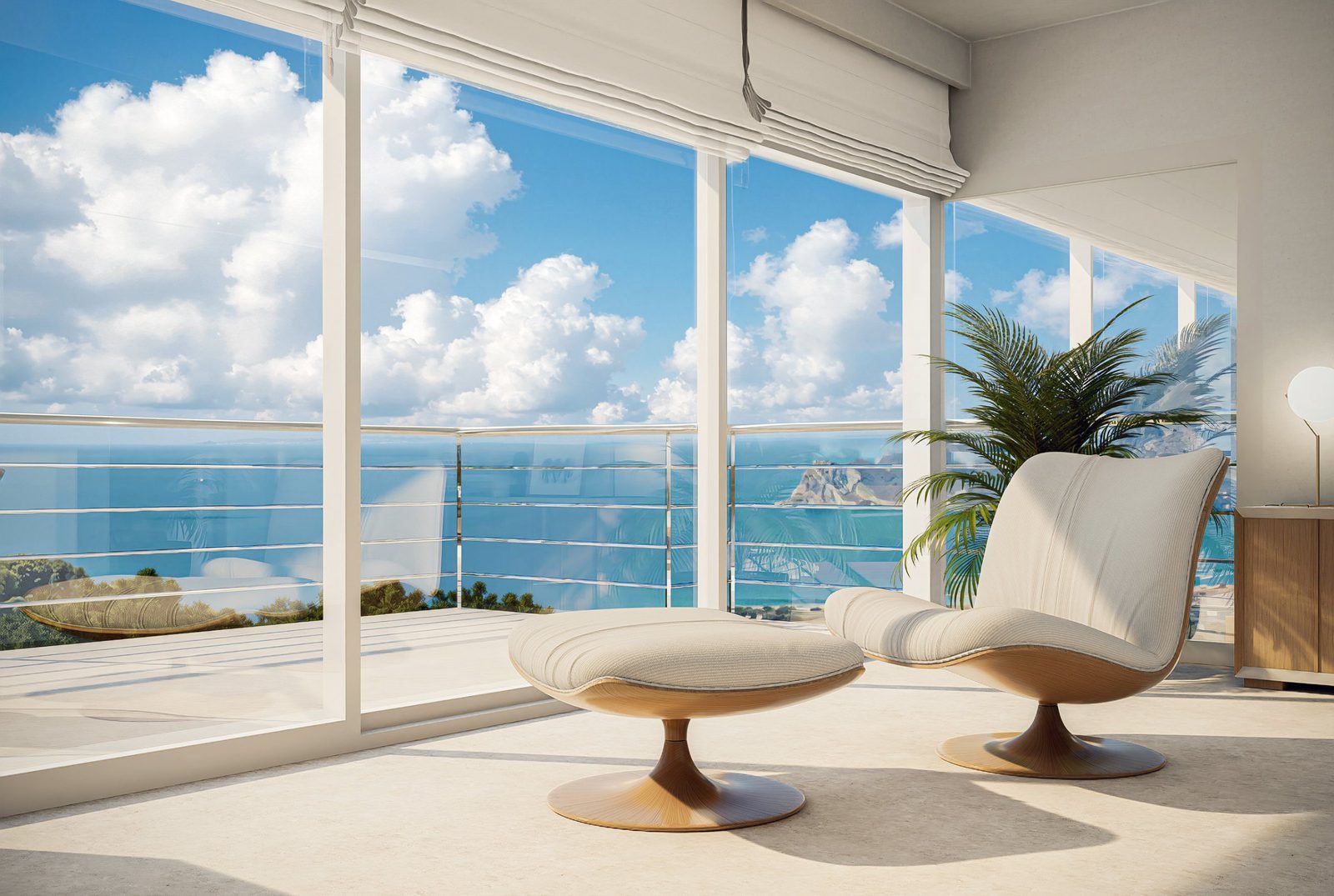 Bright sitting area with lounge chairs and sea views through floor-to-ceiling windows of a