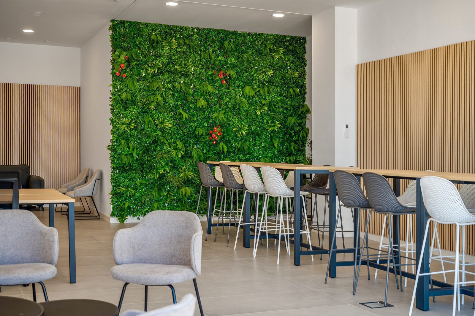 A modern communal space with a living wall and seating area in a 2-bedroom apartment in Finestrat - The Estates