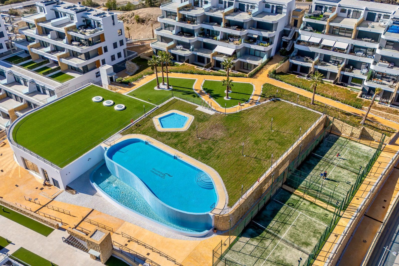 Aerial view of the communal pool and gardens of a 2-bedroom apartment in Finestrat - The Estates
