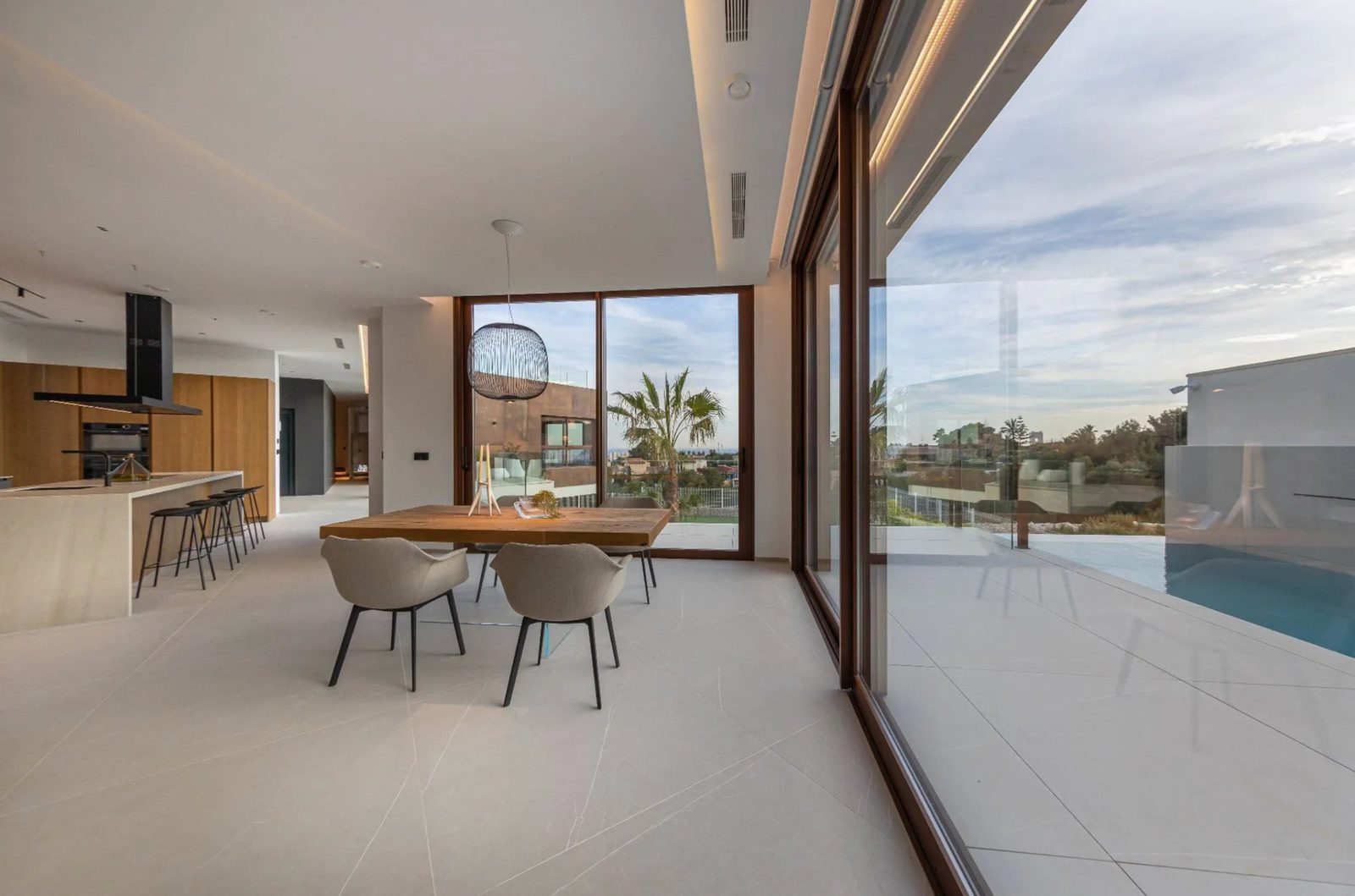 Modern dining area with stunning sea views inside a 4-bedroom villa in Benidorm - The Estates