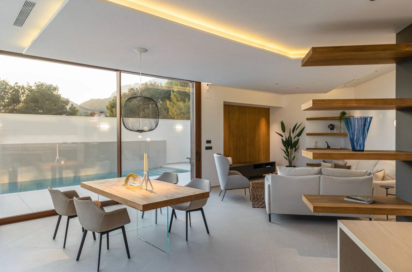 Stylish living and dining area with sea views inside a 4-bedroom villa in Benidorm - The Estates