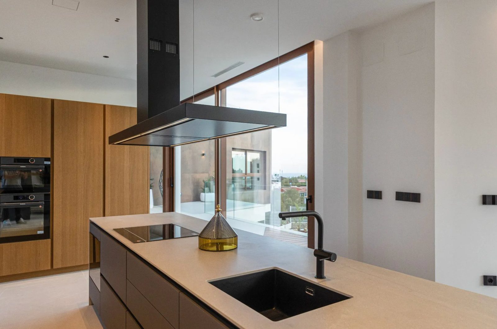 Modern kitchen with sleek appliances and stunning sea views in a 4-bedroom villa in Benidorm - The Estates