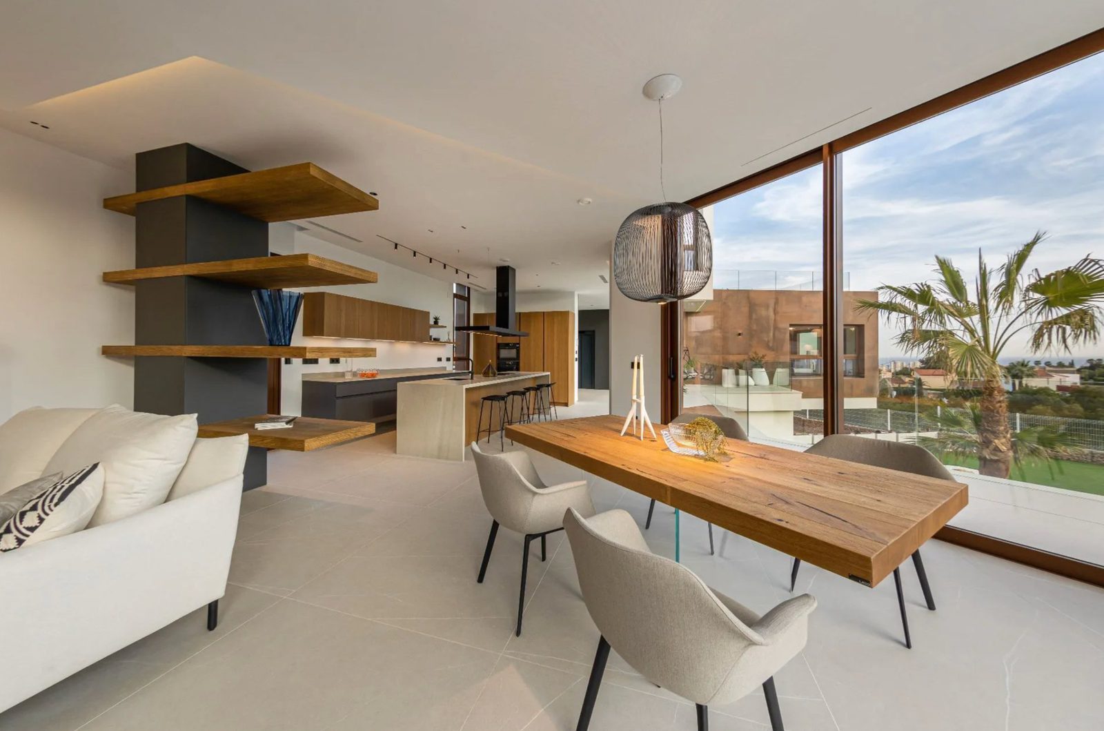 Modern dining and living area with sea views in a 4-bedroom villa in Benidorm - The Estates