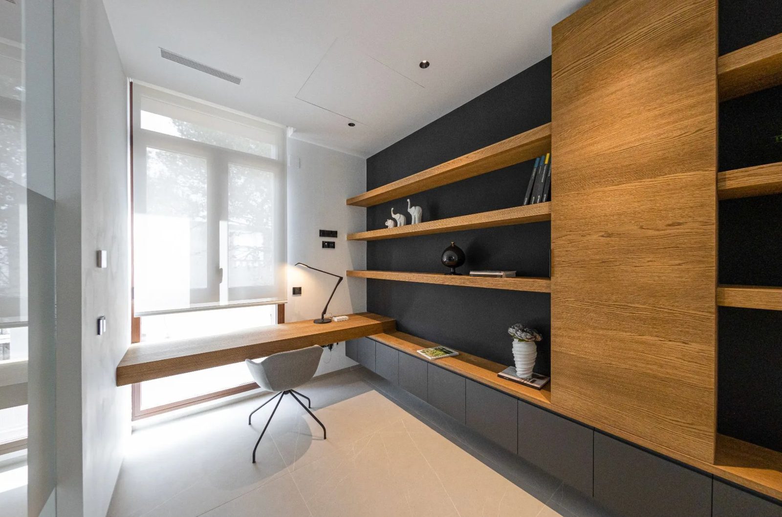 A modern study space with wooden shelving and a desk in a 4-bedroom villa in Benidorm - The Estates