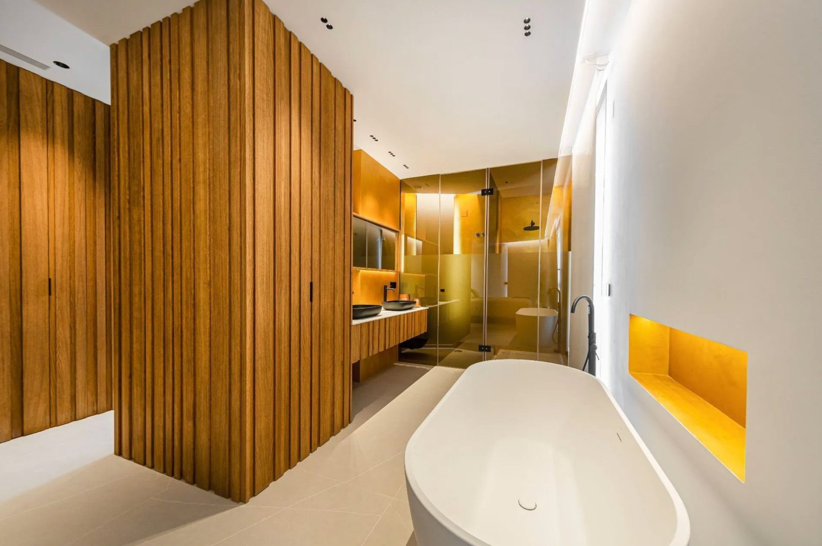 A modern bathroom with a freestanding tub and walk-in shower in a 4-bedroom villa in Benidorm - The Estates