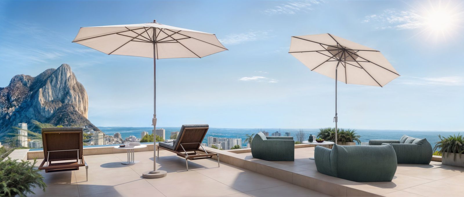 A sun-drenched terrace with lounge chairs and umbrellas overlooking mountains and the sea - The Estates